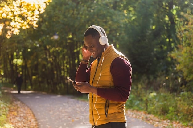 A person jogging on a scenic trail during sunrise, with headphones on and a focused expression.