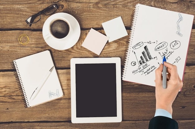 A person sketching a detailed business plan with a pen on a notebook, surrounded by financial charts and market analysis printouts, illustrating the planning phase of a startup.