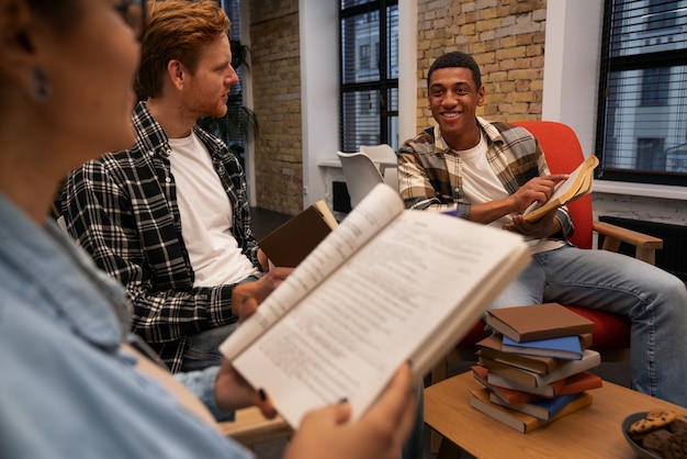 A diverse group of students, some with textbooks open, engaged in a discussion on a college campus lawn, symbolizing academic pursuit and community support. The background shows university buildings, conveying a sense of higher learning.