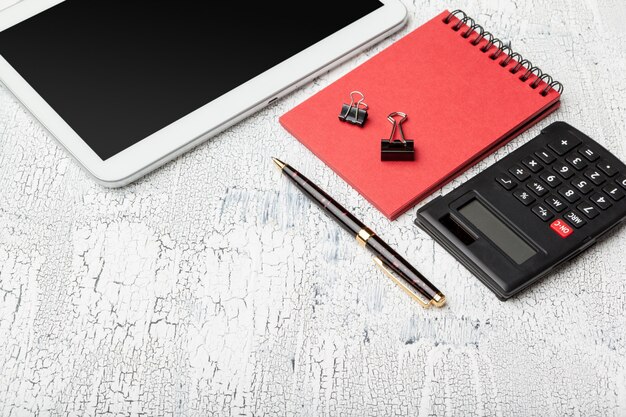 A calculator displaying numbers on a desk, next to a pen and a social security statement, symbolizing financial calculations and planning.
