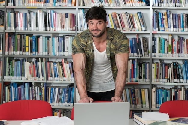 A veteran studying in a university library, surrounded by books and a laptop, highlighting educational pursuit.